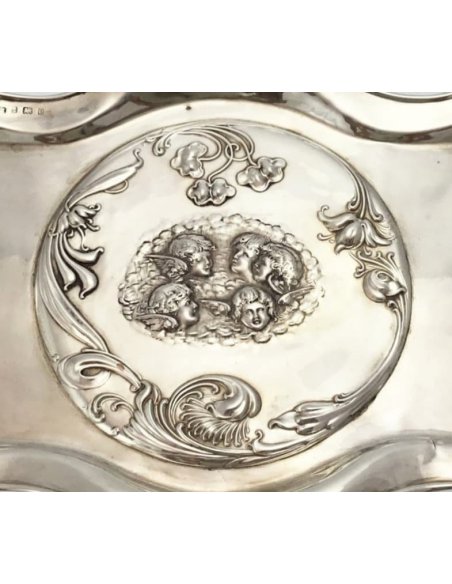 Medallion and four putti heads on a silver tray by W.G.Keight, Birmingham 1904.
