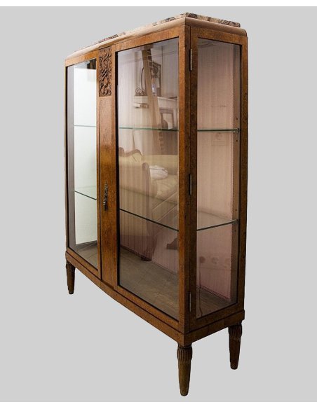 Side view of the Art Deco display cabinet made of burl wood veneer with floral carving on fluted legs